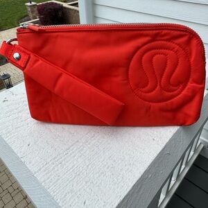 Lululemon Athletica Burnt Orange Curved wristlet